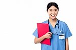Lady Doctor Holding Clipboard And Posing Stock Photo