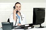 Lady Doctor Talking Over Phone Stock Photo