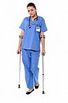Lady Doctor Walking With Help Of Crutches Stock Photo