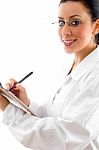 Lady Doctor Writing On Clipboard Stock Photo