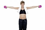 Lady Enjoying Music And Exercising With Dumbbells Stock Photo