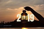 Lamp On Hand In Sunbeam Over Sunset With 2019 . Power And Idea C Stock Photo