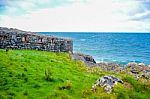 Landscape View Of Peel Hill Rocky Seashore With Great Wall Of Peel Castle In Background, Isle Of Man Stock Photo