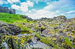 Landscape View Of Peel Hill Rocky Seashore With Great Wall Of Peel Castle In Background, Isle Of Man Stock Photo