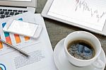 Laptop, Tablet , Smartphone And Coffee Cup With Financial Docume Stock Photo