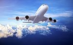 Large Passenger Plane Flying In The Blue Sky Stock Photo