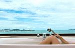 Leg In Bathtub On Sea View Background Stock Photo