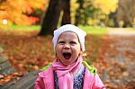 Lifestyle Portrait Of Little Happy Girl  In Autumn Park Stock Photo