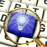 Light Bulb Key Magnified Means Bright Idea Innovation Or Inventi Stock Photo