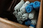 Light Gray And Blue Rolled Spa Massage Towel In The Wooden Box Stock Photo
