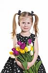 Liittle Girl With Tulips Stock Photo