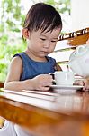 Little Asian Girl (thai) Holding A Cup Stock Photo