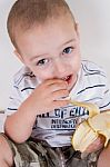 Little Boy Holding Peeled Banana Stock Photo