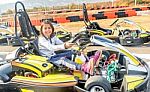 Little Girl Is Driving Go- Kart Car In A Playground Racing Track Stock Photo