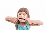 Little Girl Making A Strange Face On White Background Stock Photo