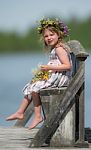 Little Girl On A Bench By A Lake Stock Photo
