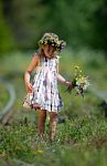 Little Girl Picking Wild Flowers By A Railroad Stock Photo