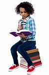 Little Girl Reading Book Using Magnifying Glass Stock Photo