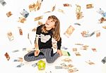 Little Girl Saving Money In Piggy Bank With Money Bills Flying Everywhere Around Stock Photo