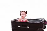 Little Girl Sitting In Suitcase Stock Photo