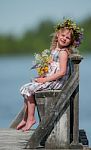 Little Girl Sitting On A Bench Stock Photo