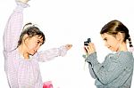 Little Girl Taking Pictures Of Her Sister With Camera Isolated On White Stock Photo