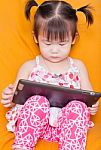 Little Girl Using A Tablet Stock Photo