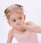 Little Girl With Hand Over Mouth Stock Photo