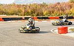 Little Girls Are Driving Go- Kart Car In A Playground Racing Track Stock Photo