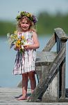 Little Seriously Looking Girl With Flowers Stock Photo