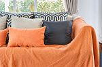 Living Room With Orange Color Blanket With Pillows On Sofa Stock Photo