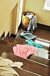 Lots Of Messy Clothes On A Cloth Basket And Stair Stock Photo