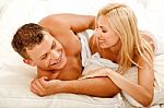 Lovers In Bed Laughing Stock Photo