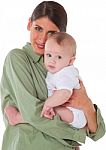 Loving Young Mother Carrying Baby Boy Stock Photo