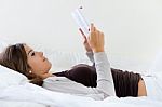 Lying Beautiful Woman Reading Book At Home Stock Photo