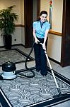 Maid Cleaning With Vacuum Cleaner Stock Photo