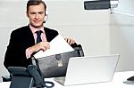 Male Call Centre Executive Arranging Paper Works Stock Photo
