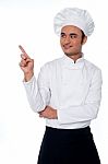 Male Chef Looking And Pointing Away Stock Photo