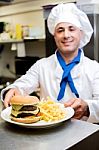 Male Chef Serving The Order Stock Photo