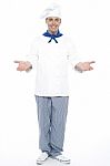Male Chef Showing Welcome Gesture Stock Photo