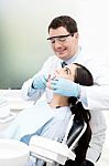 Male Dentist Attending His Patient Stock Photo