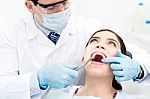 Male Dentist Treat A Woman Patient Stock Photo