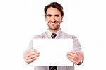Male Executive Holding Out Blank Ad Board Stock Photo