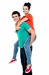 Male Giving Piggyback Ride Stock Photo