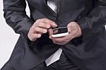 Male Hand Reviewing Information On Smart Phone Stock Photo