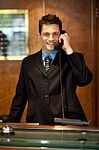 Male Receptionist Talking Phone Stock Photo