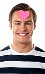 Male With Paper Heart On Forehead Stock Photo