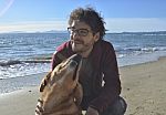 Man And Dog On The Beach Stock Photo