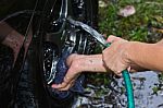 Man cleaning car with water Stock Photo