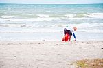 Man Cleaning Rubbish At Beach Stock Photo